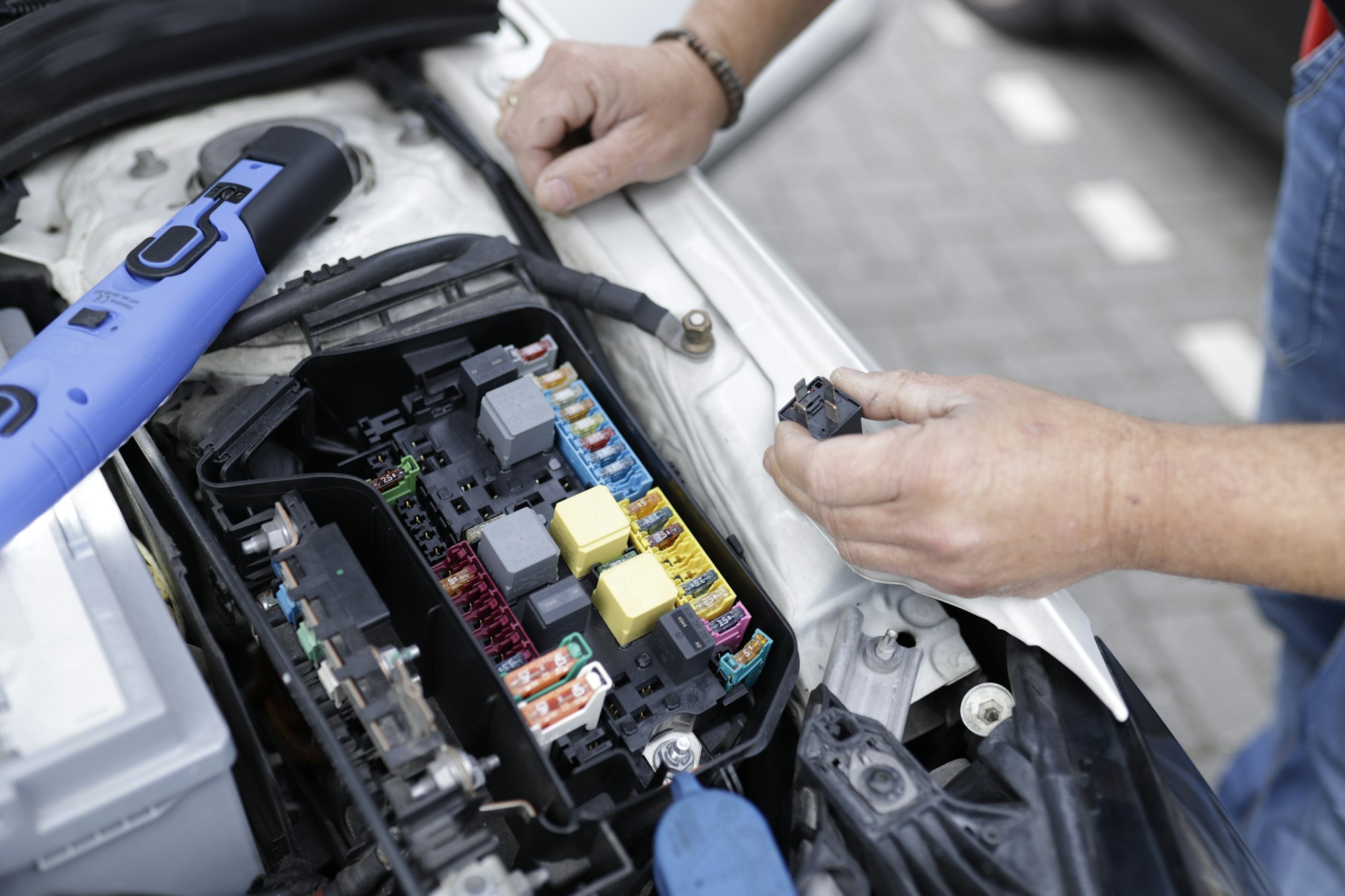 Auto shop service bay with a vehicle on a lift